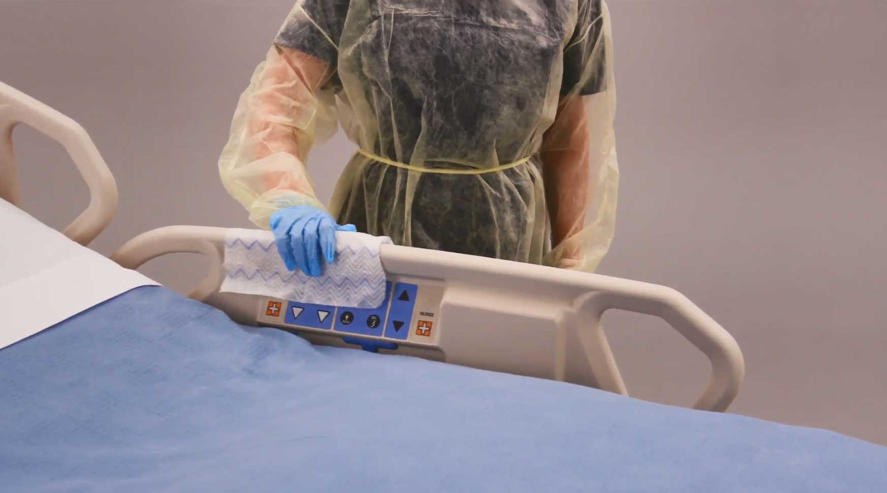 A hospital staff cleaning the bed frame with HYGEN™ Disposable Microfiber Cloth