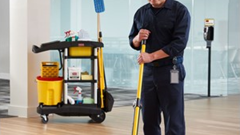 A worker spotted using Rubbermaid Commercial Janitorial Cleaning Cart, HYGEN™ PULSE™ Microfiber Mop Kit, and AutoFoam Premium Floor Stand