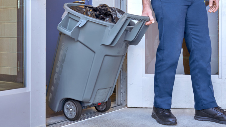 Man with RUBBERMAID WHEELED BRUTE CONTAINER