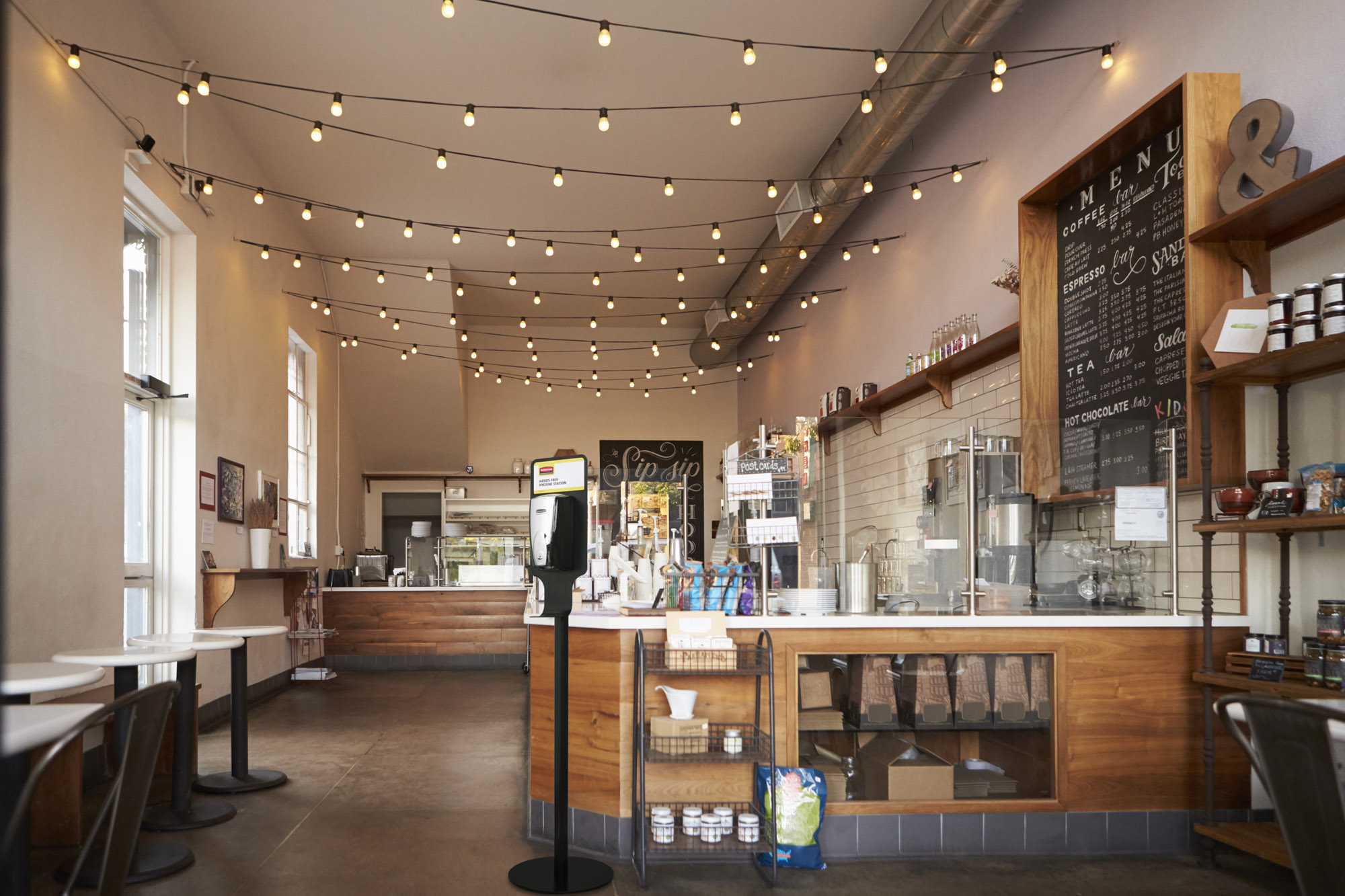 Rubbermaid Pump Top Sanitiser Floor Stand in a Coffee Shop